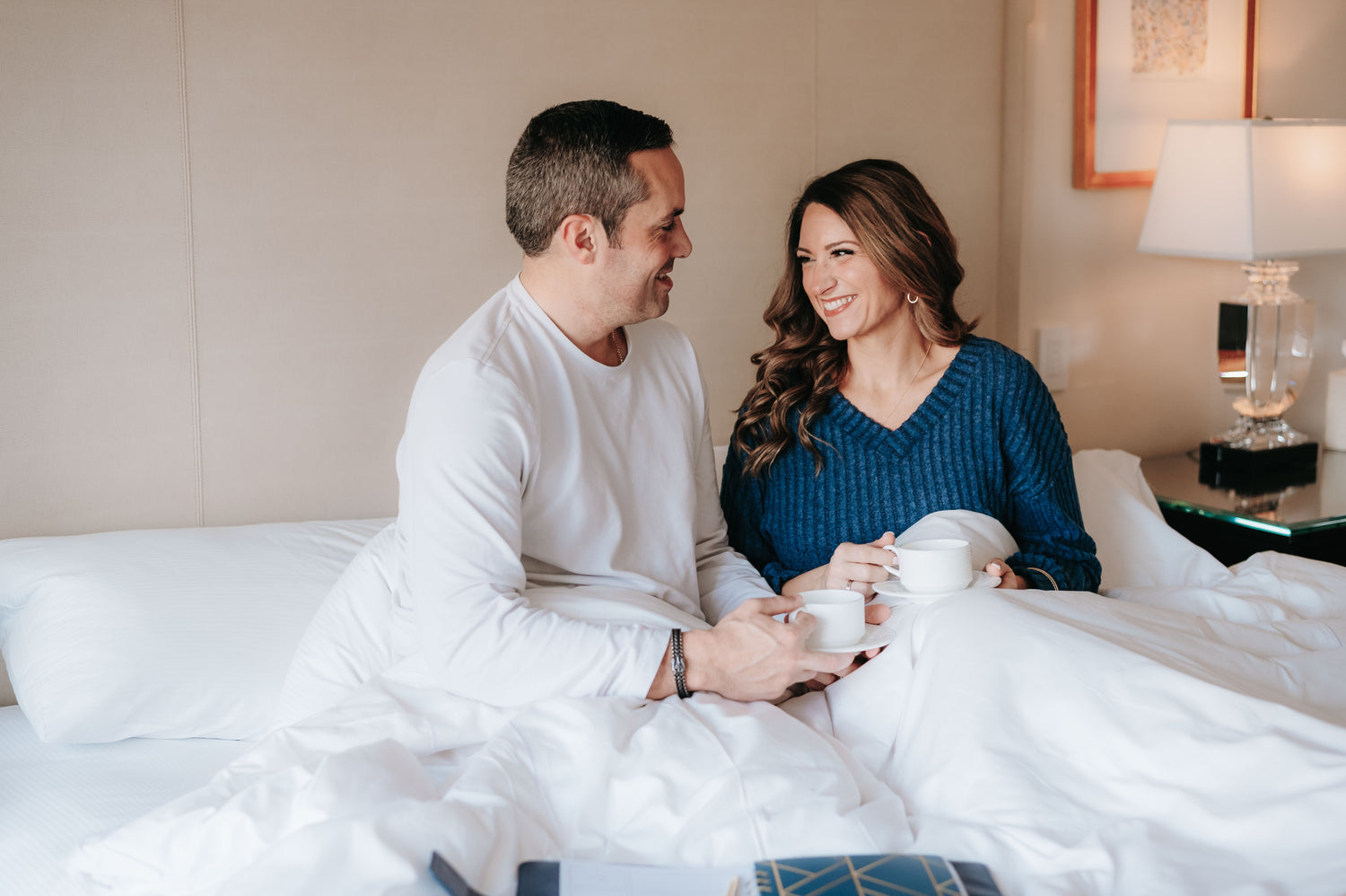 Married couple enjoying coffee together in bed, representing intentional daily connection, communication, and a Christ-centered marriage.