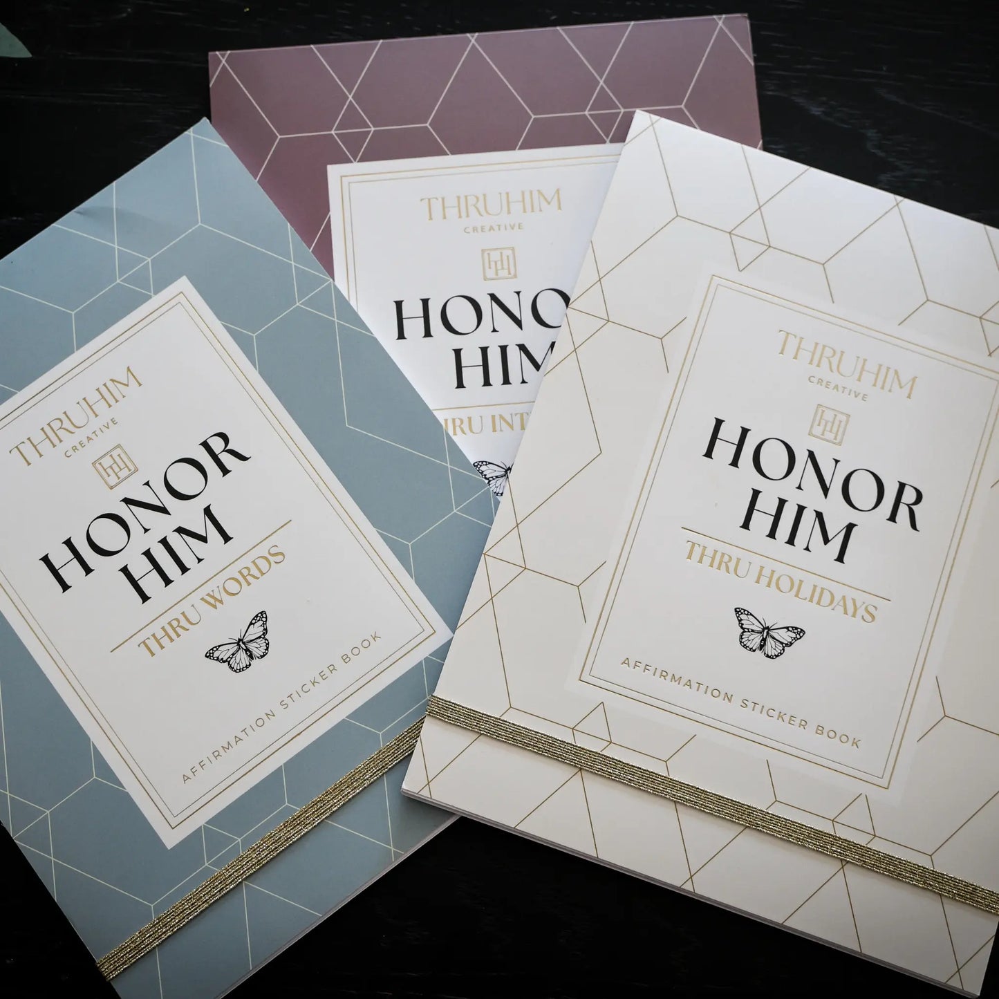 Honor Him physical affirmation sticker book collection featuring the Thru Words, Thru Intimacy, and Thru Holidays sticker books designed to complement the Honor Him Marriage Transformation System.