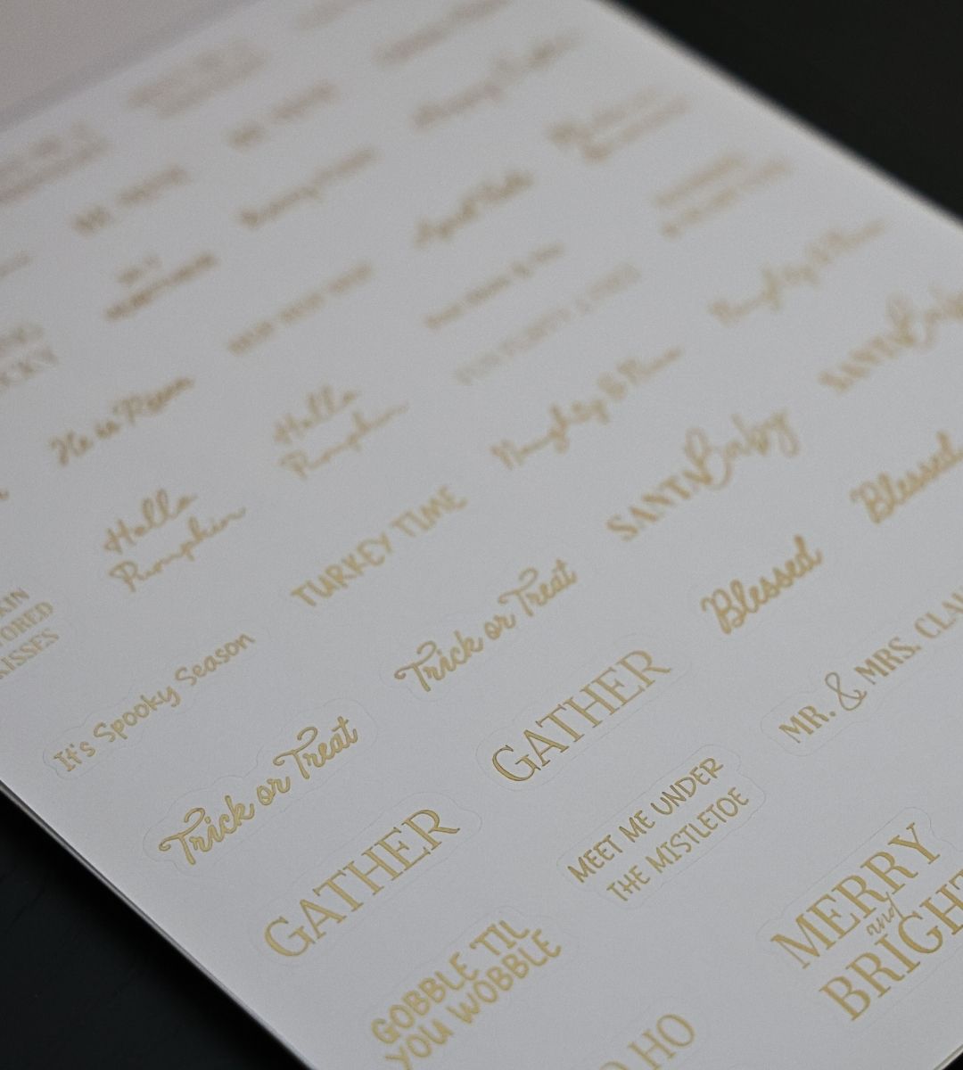 Holiday phrase and word stickers from the Honor Him Thru Holidays Affirmation Sticker Book with seasonal sentiments and gold foil lettering.