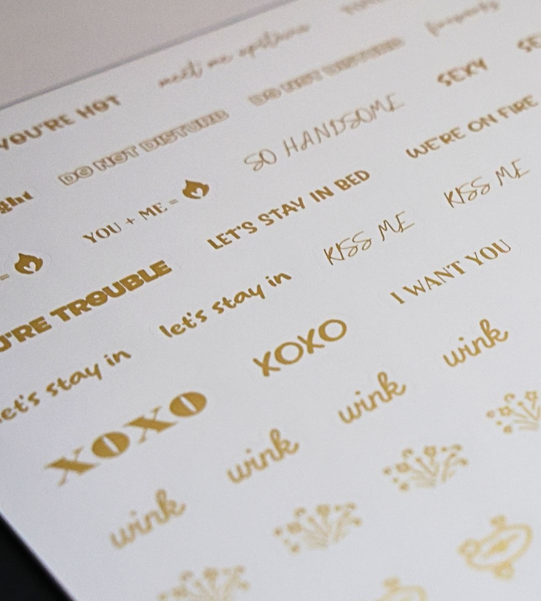 Close-up of the Honor Him Thru Intimacy Affirmation Sticker Book featuring romantic phrase stickers, kiss icons, and playful marriage planner stickers.