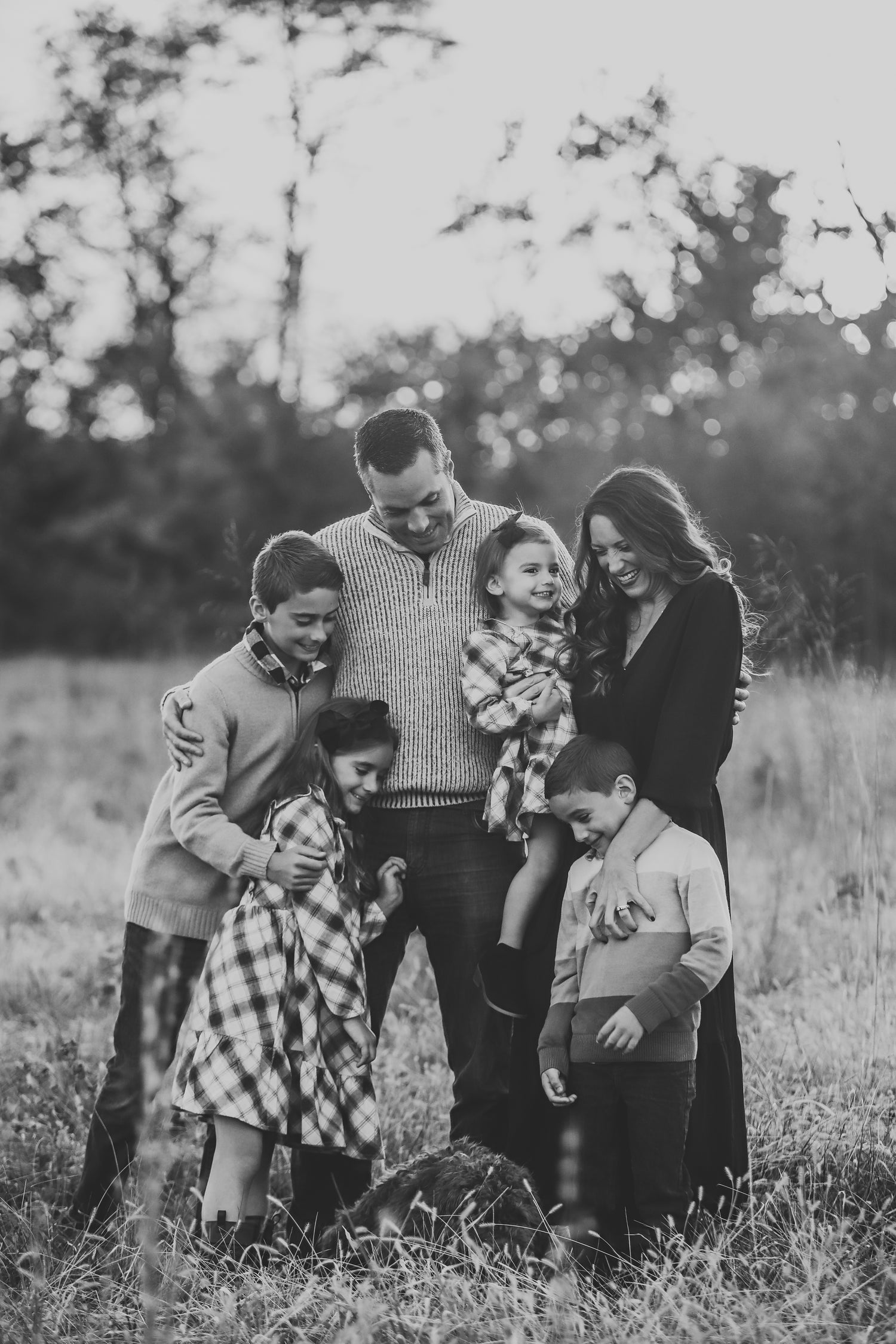 Family portrait of the founder of ThruHim Creative with her husband and children, sharing the story and inspiration behind the Honor Him marriage planner and affirmation sticker collection.