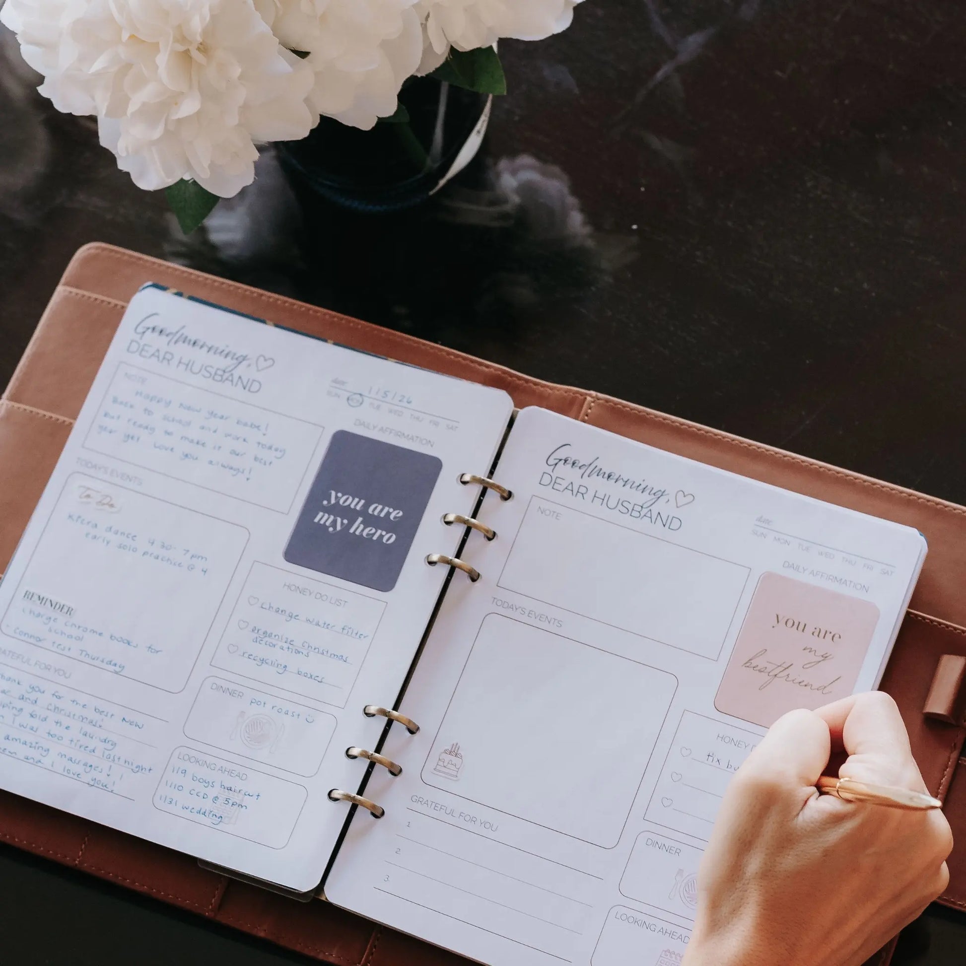 Person using the Honor Him guided Christian marriage transformation system inside a cognac leather padfolio